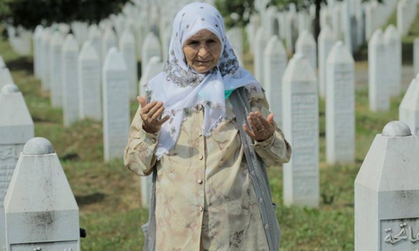 Srebrenitsalı aileler, evlatlarının mezarı başında dua ediyor